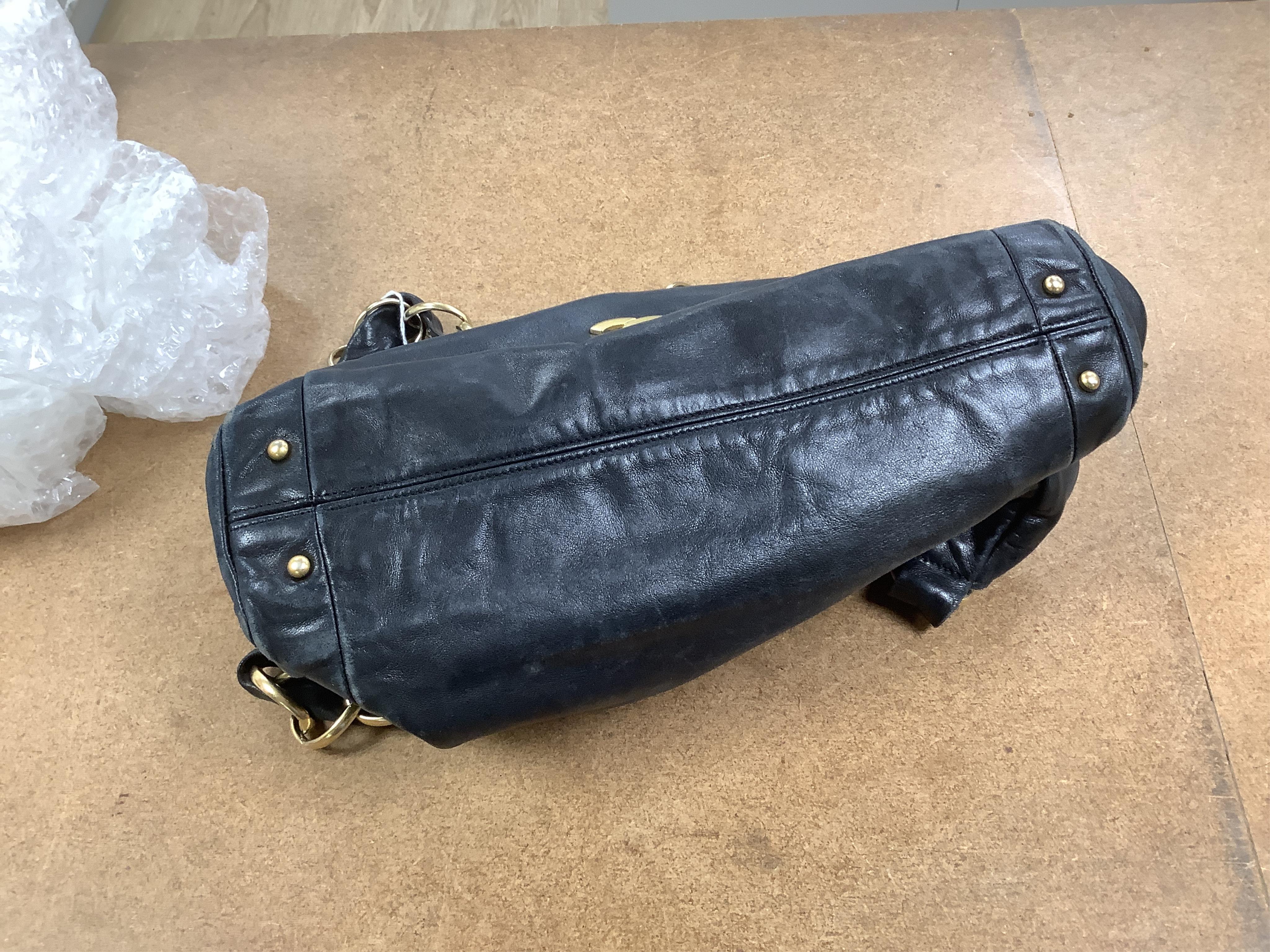 An early 2000’s Chanel black leather handbag with gold hardware, date code 7949937, 31cm wide